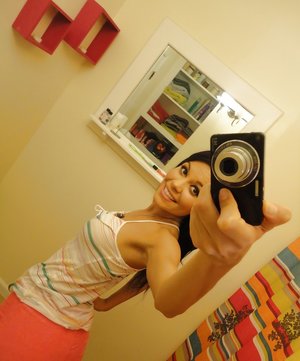 18 year old female Doris G slips off her underwear to pose naked on her bed